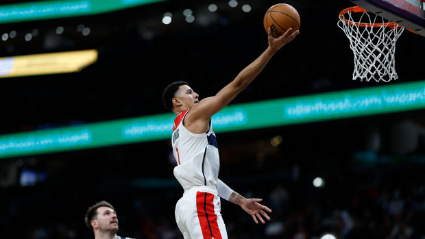 Washington Wizards guard Johnny Davis (1) shoots the ball as Dallas Mavericks guard Luka Doncic (77) looks on in the fourth quarter at Capital One Arena. 