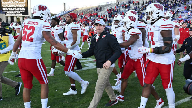 Wisconsin head coach Jim Leonhard celebrating a win with his team.