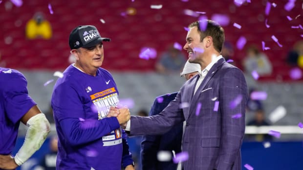 Dec 31, 2022; Glendale, Arizona, USA; TCU Horned Frogs head coach Sonny Dykes celebrates on the podium with athletic director Jeremiah Donati after defeating the Michigan Wolverines in the 2022 Fiesta Bowl at State Farm Stadium.