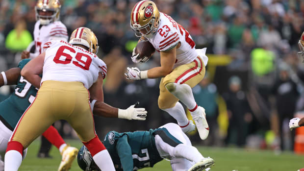 Jan 29, 2023; Philadelphia, Pennsylvania, USA; San Francisco 49ers running back Christian McCaffrey (23) leaps over Philadelphia Eagles safety Marcus Epps (22) on way to a 23-yard touchdown run during the second quarter in the NFC Championship game at Lincoln Financial Field. Mandatory Credit: Bill Streicher-USA TODAY Sports  