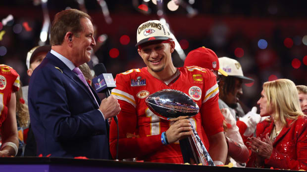 Kansas City Chiefs quarterback Patrick Mahomes celebrates with the Vince Lombardi Trophy after Super Bowl LVIII.