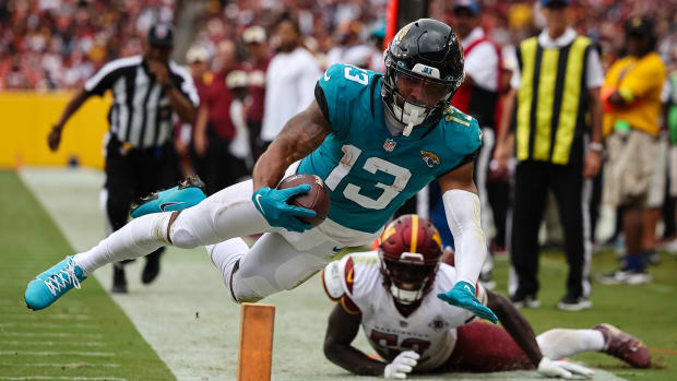 Sep 11, 2022; Landover, Maryland, USA; Jacksonville Jaguars wide receiver Christian Kirk (13) dives for the end zone in front of Washington Commanders linebacker Jamin Davis (52) during the second half at FedExField. Kris was ruled out of bounds on the play. Mandatory Credit: Scott Taetsch-USA TODAY Sports