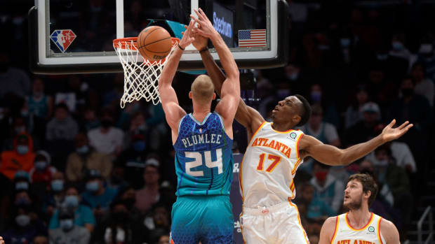 Jan 23, 2022; Charlotte, North Carolina, USA; Charlotte Hornets forward center Mason Plumlee (24) is defunded by Atlanta Hawks center Onyeka Okungwu (17) during the first half at The Spectrum Center.