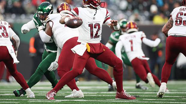 Washington Commanders quarterback Jacoby Brissett (12) throws the ball during the second half against the New York Jets at MetLife Stadium.