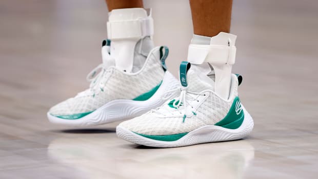 View of white and green Curry shoes.