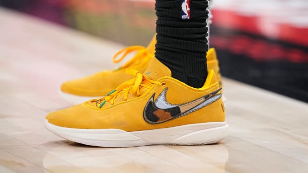 View of yellow and white Nike LeBron shoes.