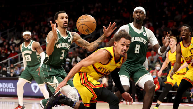 Jan 17, 2022; Atlanta, Georgia, USA; Atlanta Hawks guard Trae Young (11) looses control of the ball against Milwaukee Bucks guard George Hill (3) and center Bobby Portis (9) during the second quarter at State Farm Arena.