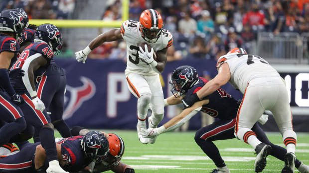 Dec 4, 2022; Houston, Texas, USA; Cleveland Browns running back Jerome Ford (34) leaps with the ball as Houston Texans linebacker Jake Hansen (49) attempts to make a tackle during the fourth quarter at NRG Stadium. Mandatory Credit: Troy Taormina-USA TODAY Sports