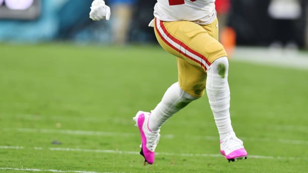 View of San Francisco 49ers wide receiver Deebo Samuel's white and pink Air Jordan cleats.