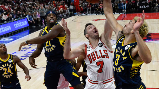 Chicago Bulls point guard Goran Dragic battles for a rebound against Indiana Pacers' Terry Taylor and Chris Duarte at the United Center.
