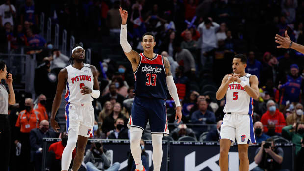 Washington Wizards forward Kyle Kuzma (33) celebrates his three point basket in overtime as Detroit Pistons forward Jerami Grant (9) reacts at Little Caesars Arena.