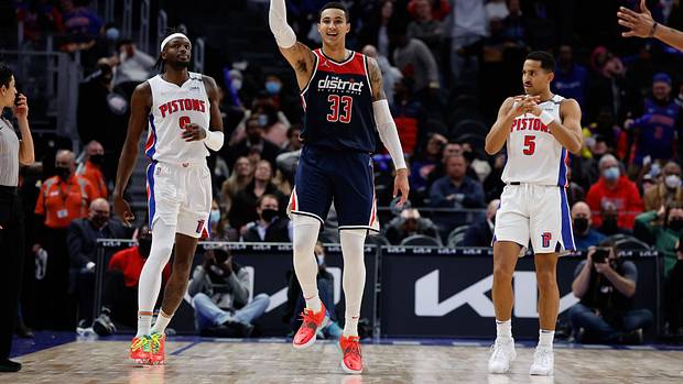 Washington Wizards forward Kyle Kuzma (33) celebrates his three point basket in overtime as Detroit Pistons forward Jerami Grant (9) reacts at Little Caesars Arena.