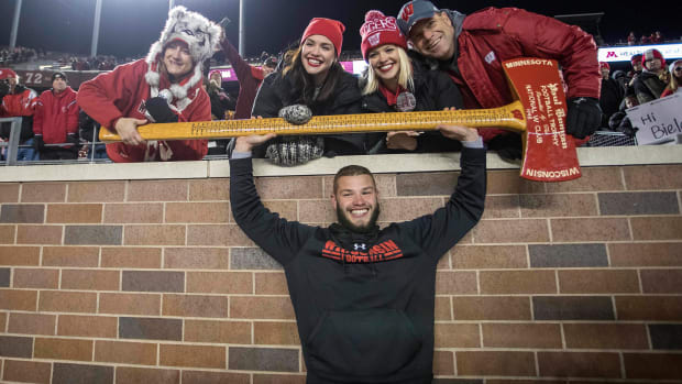 Wisconsin linebacker Jack Cichy posing with the Axe after beating Minnesota (Credit: Jesse Johnson-USA TODAY Sports)