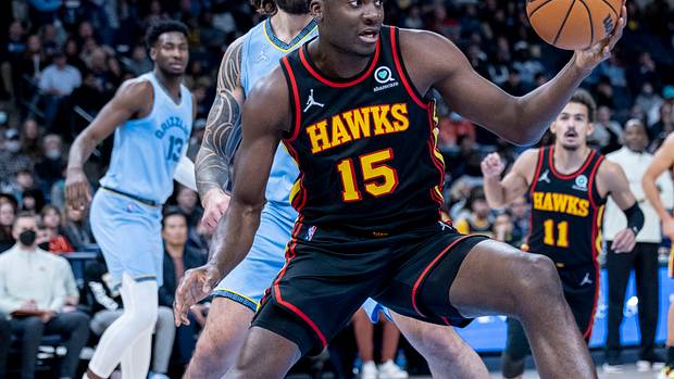Hawks center Clint Capela rebounds the ball in front of Grizzlies center Steven Adams.