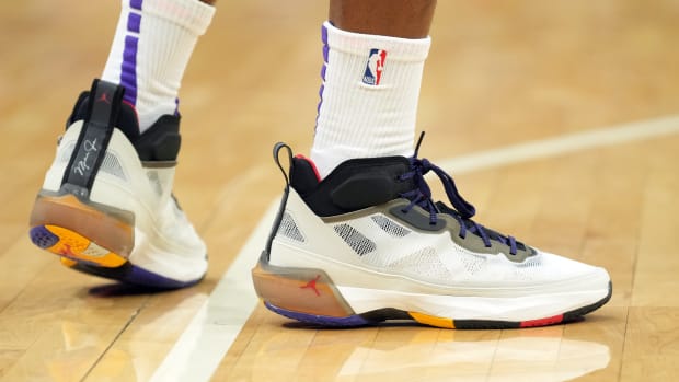 View of Harrison Barnes' white and black Air Jordan basketball shoes.