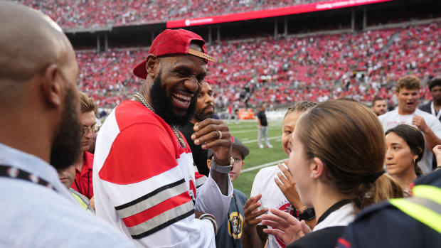 LeBron James talks to fans before the football game.