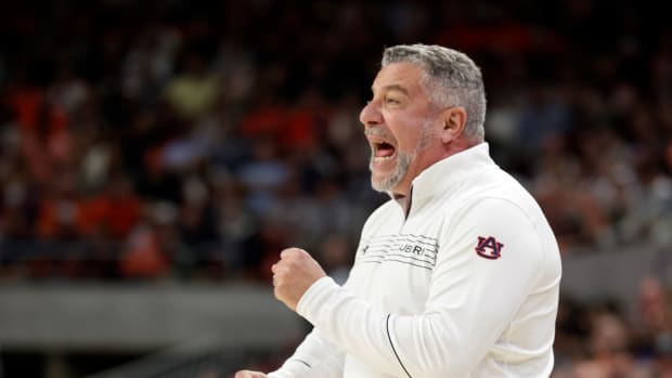 Auburn head coach Bruce Pearl signals to players during the first half of an NCAA college basketball game against South Carolina, Saturday, March 5, 2022, in Auburn, Ala. (AP Photo/Butch Dill)