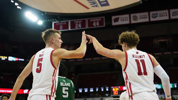 Wisconsin starters Tyler Wahl and Max Klesmit high five after a play against UW-Green Bay.