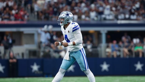 Dallas Cowboys quarterback Dak Prescott reacts after throwing a touchdown pass.