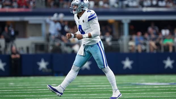 Dallas Cowboys quarterback Dak Prescott reacts after throwing a touchdown pass.