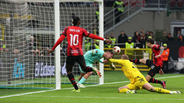 Rafael Leao pictured (left) watching on as Christian Pulisic (right) volleys the ball into the net to score for AC Milan in a 4-2 win over Slavia Prague in March 2024