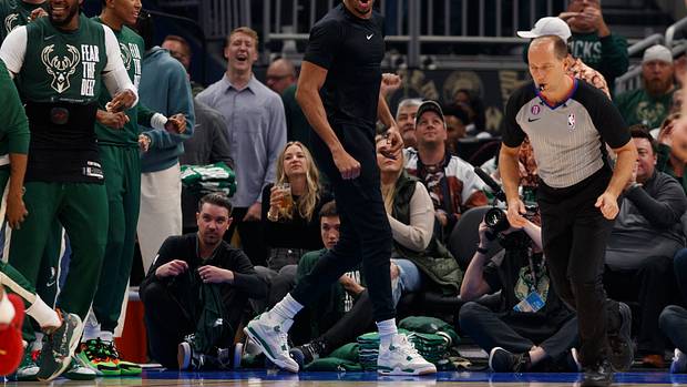 Milwaukee Bucks forward Giannis Antetokounmpo cheers from the bench.