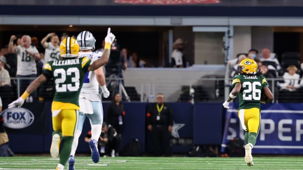 Green Bay Packers safety Darnell Savage (26) intercepts a pass for a touchdown against the Dallas Cowboys in the first half of the 2024 NFC wild card game at AT&T Stadium. Mandatory Credit: Kevin Jairaj-USA TODAY Sports