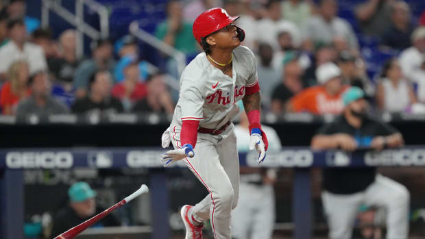 Jul 7, 2023; Miami, Florida, USA; Philadelphia Phillies left fielder Cristian Pache (19) watches his two-run home run clear the wall in the ninth inning against the Miami Marlins at loanDepot Park. Mandatory Credit: Jim Rassol-USA TODAY Sports