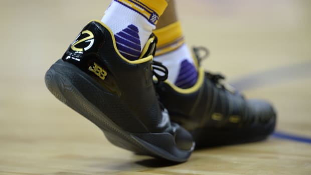 A detailed view of Lonzo Ball's black and gold sneakers.
