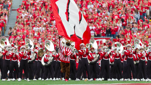 Bucky Badger waving the flag with the Wisconsin band in the background (Credit: Jeff Hanisch-USA TODAY Sports)
