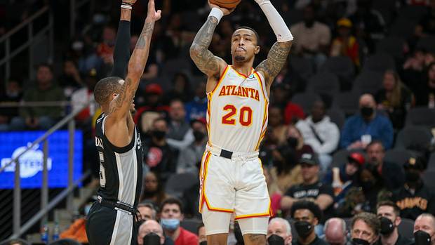 Atlanta Hawks forward John Collins (20) shoots over San Antonio Spurs guard Dejounte Murray (5) in the second half at State Farm Arena.