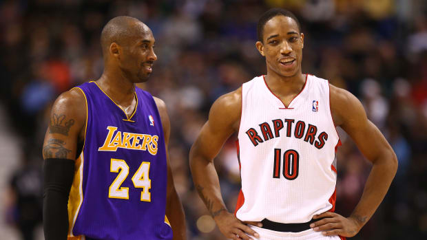 Los Angeles Lakers legend Kobe Bryant talks to then-Toronto Raptors forward DeMar DeRozan in 2013.