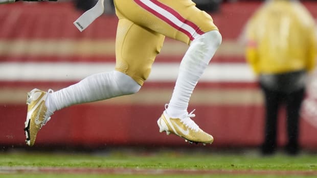 San Francisco 49ers wide receiver Deebo Samuel's gold and white Nike cleats.