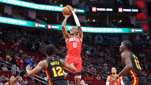 Rockets forward Jabari Smith Jr. (10) shoots the ball as Atlanta Hawks forward De'Andre Hunter (12) defends during the first quarter at Toyota Center.