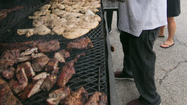 J.B. from Chicago, as he calls himself, checks the chicken at D's & C's Barbecue out of Lansing at the Smokin' Jazz and Barbecue Blues Festival Friday, Sept. 6, 2019. Smokin Jazz Bbq Blues 19 04