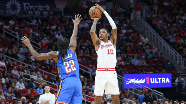 Rockets forward Jabari Smith Jr. (10) shoots the ball over Oklahoma City Thunder guard Cason Wallace (22) during the first quarter at Toyota Center.