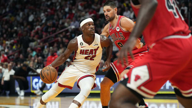 Oct 19, 2022; Miami, Florida, USA; Miami Heat forward Jimmy Butler (22) drives past Chicago Bulls center Nikola Vucevic (9)