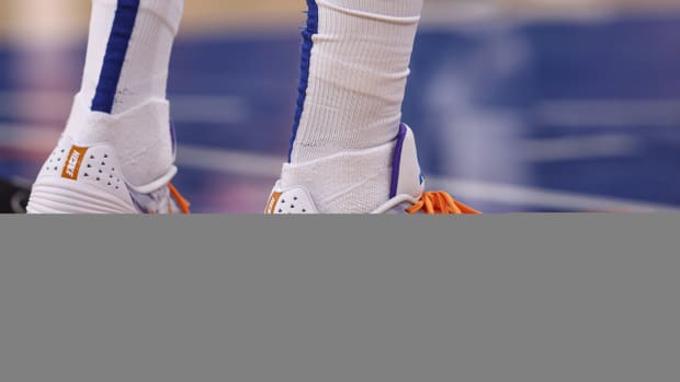 A view of white and orange Nike shoes.