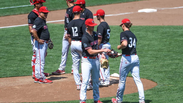 Reid Johnston hands the ball to Evan Justice in Omaha, Nebraska during the 2021 College World Series. Johnston is currently with Lynchburg in the Cleveland organization, while Justice pitches for Spokane in the Colorado minor league system. 