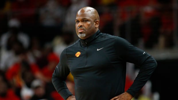 Nate McMillan stands on the sideline during a game.
