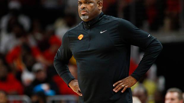 Nate McMillan stands on the sideline during a game.