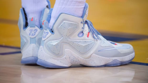 View of white and blue Nike LeBron shoes.