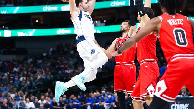 Dallas Mavericks superstar Luka Doncic takes flight as three Chicago Bulls look on.