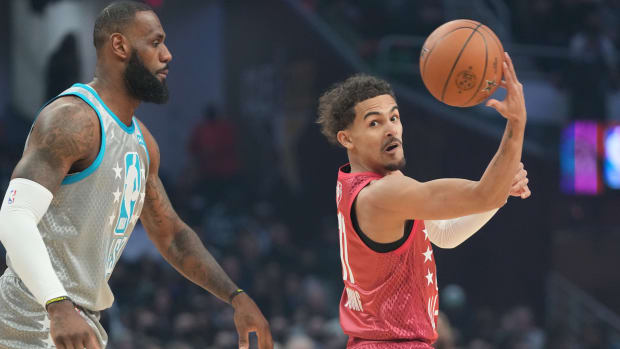 Trae Young passes the ball away from LeBron James in the 2022 NBA All-Star Game.