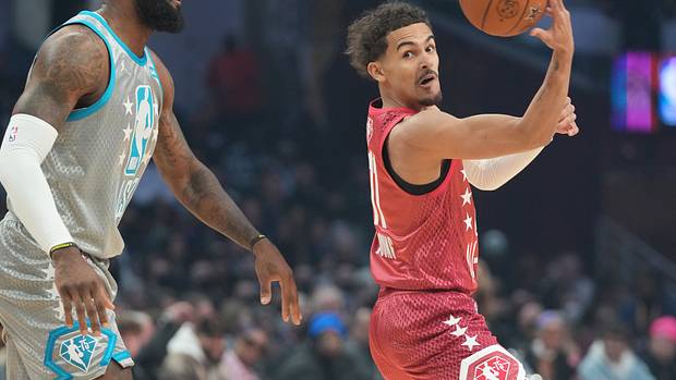 Trae Young passes the ball away from LeBron James in the 2022 NBA All-Star Game.