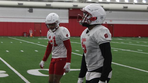 Cedrick Dort (No. 5) and Avyonne Jones (No. 21) hustle back after a special team's drill.