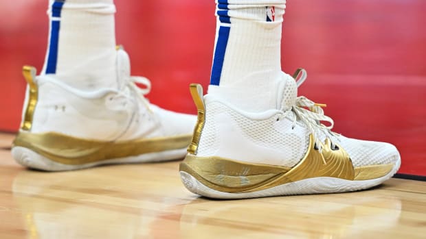 Philadelphia 76ers center Joel Embiid's white and gold Under Armour shoes.