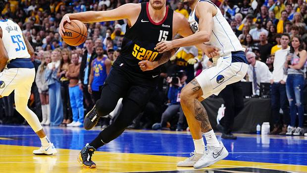 Dallas Mavericks rookie Dereck Lively II defends Denver Nuggets' Nikola Jokic.