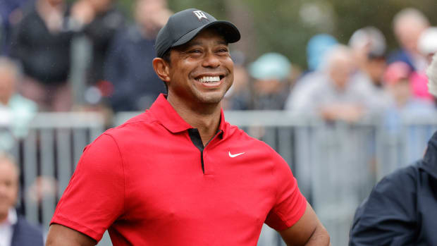 Tiger Woods smiles between shots at the PNC Championship.