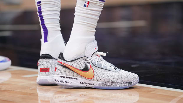 View of LeBron James' white and gold Nike shoes.